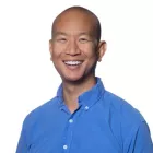 Man smiling in a blue shirt